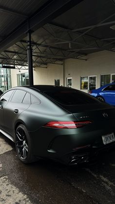 a black car parked in front of a building