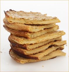 a stack of toasted bread sitting on top of each other in front of a white background