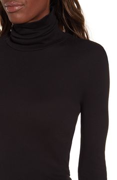 A timeless stretch-jersey turtleneck is updated with a trim fit. 26" length (size Medium). Semi-sheer. 50% pima cotton, 50% modal. Machine wash cold, tumble dry low. By Splendid; made in the USA. t.b.d.