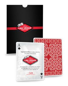 two playing cards in front of a black box with red and white designs on it