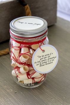 a jar filled with white and red marshmallows