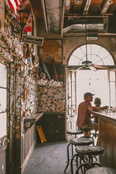 a man sitting at a bar with an american flag hanging from the ceiling