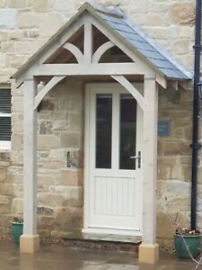 a small white door sitting next to a brick building