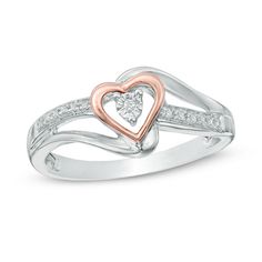 a heart shaped diamond ring with two tone gold and white diamonds in the center, set on