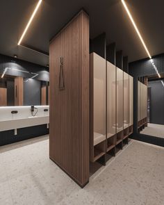 a bathroom with several stalls and sinks in the middle, all made out of wood