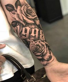 a woman's arm with roses and the word aro tattooed on it