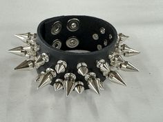 Three Row 1/2" Spike Bracelet Genuine Cowhide 7oz Weight Leather Bracelet Snap Bracelet 7oz Cowhide Leather Military Grade Rust Protected Spikes SIZE:    ALL BRACELET ARE 9"-9 1/2" LONG.  FITS 7"-9"  WRISTS Silver Rivets Wristband For Concert, Rock Style Wristband With Rivets For Concerts, Adjustable Silver Bracelet With Spikes, Punk Style Adjustable Cuff Bracelet With Rivets, Punk Adjustable Cuff Bracelet With Rivets, Adjustable Punk Cuff Bracelet With Rivets, Punk Studded Bracelets For Festivals, Punk Style Studded Bracelets For Festivals, Metal Studded Bracelets For Concerts