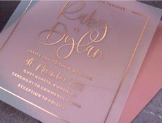 two pink and gold wedding cards on top of each other