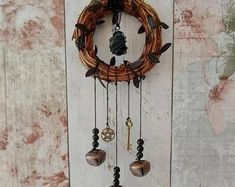 a wooden door with a clock hanging from it's side and beads attached to the front