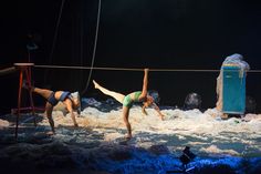 two women in bathing suits are performing on rope