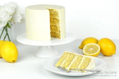 a slice of cake on a plate next to some lemons