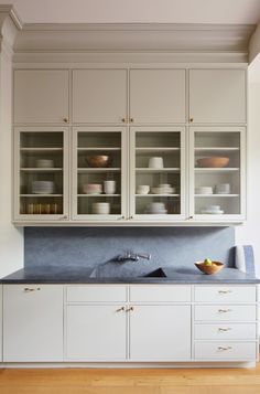 a kitchen with white cabinets and blue counter tops