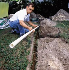 a man laying on the ground with a white pipe