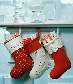 an image of christmas stockings hanging from a rack on the wall next to wine glasses