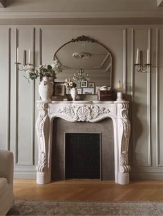 a living room with a fire place and a mirror on the wall above it's mantle