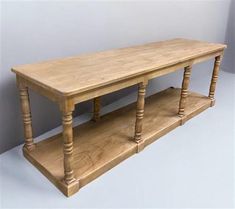 a wooden table with two shelves on each side