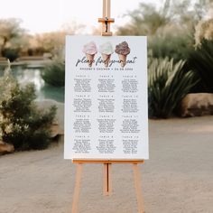 an easel with a wedding seating chart on it