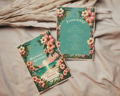 two birthday cards sitting on top of a bed next to each other with flowers and leaves