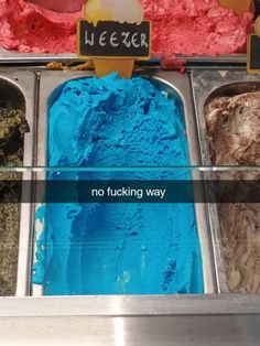 an ice cream shop with blue and red colors in it's display case,