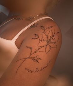 a woman's arm with a flower tattoo on the left side of her body