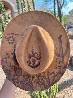 Unleash your individuality with our Custom Burned Hats, where your story becomes wearable art. Each hat is meticulously crafted and hand-burned to capture your unique journey, just like a tattoo but on a stylish accessory. Why You'll Love It: 100% Custom: Every design is tailored to your personal story, interests, and style. Artisan Craftsmanship: Hand-burned with precision and care, ensuring a high-quality, one-of-a-kind piece. Express Yourself: From birth flowers and landscapes to meaningful symbols and quotes, your hat will be a true reflection of you. Perfect For: Personal Style: Stand out with a hat that's as unique as you are. Special Gifts: Give a thoughtful and personalized gift for birthdays, anniversaries, or any special occasion. Memorable Keepsakes: Preserve memories and milest Hat Burn Designs, Cactus Burned Hat, Artsy Adjustable Fedora With Curved Brim, Artsy Adjustable Hat With Curved Brim, Artistic Adjustable Hat Bands For Fedora, Adjustable Artsy Hats With Curved Brim, Custom Adjustable Fedora For Festival, Custom Hand Painted Adjustable Fedora, Brown Hat Bands For Western-themed Events