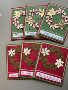 four christmas cards on top of a table