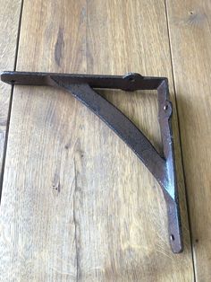 a metal object laying on top of a wooden floor