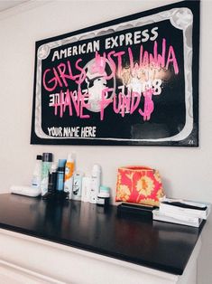 an american express sign hangs on the wall above a counter with personal care products and makeup