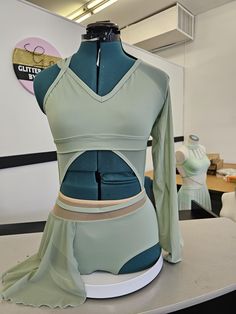 a mannequin is displayed in front of a dress form