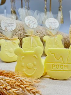 some soaps are sitting on a table with ears of wheat in the foreground