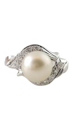 a white pearl and diamond ring