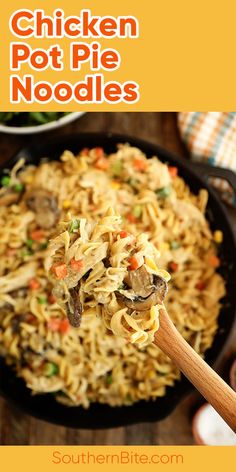 chicken pot pie noodles in a black skillet with a wooden spoon on the side