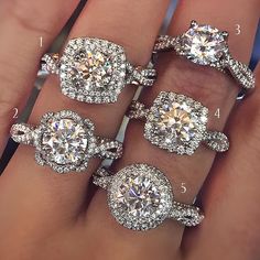 a woman's hand with five different engagement rings on it and the size of each ring