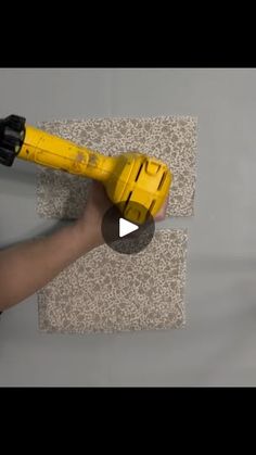 a person using a drill to fix a wall