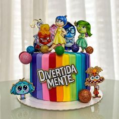 there is a colorful cake with cartoon characters on it that says divertida mente