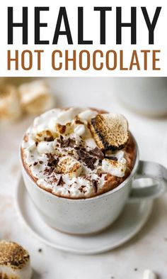 two cups filled with hot chocolate and marshmallows