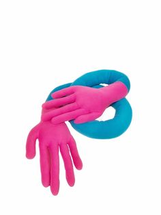 two pink and blue gloves on top of each other with one hand in the air