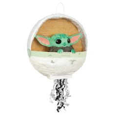 the child yoda plush toy is hanging from a chain on a white background with black and green accents