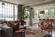 a living room filled with furniture and lots of windows