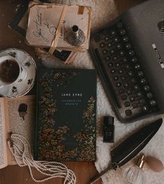 a table topped with books and a typewriter