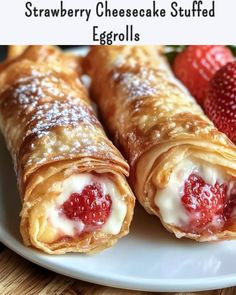 strawberry cheesecake stuffed eggrolls on a plate with strawberries