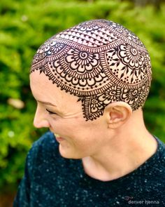 a woman with henna tattoos on her head