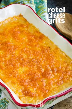 a casserole dish filled with cheese on top of a green and red cloth