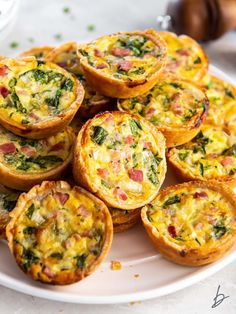 mini quiches with bacon and spinach on a white plate