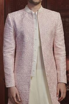 Pink sherwani with thread embroidery and sequin work. Comes with raw silk straight pants.
Component: 2
Pattern: Embroidery
Type Of Work: Thread and Sequin
Neckline: Band
Sleeve Type: Full
Fabric: Chanderi and Raw Silk
Color: Pink
Other Details: 
Slit in front
Closure: Button front
Note: Inner kurta worn by the model is not for sale
Occasion: Wedding - Aza Fashions Sawan Gandhi, Pink Sherwani, Raw Silk Embroidery, Pink Thread, Pattern Embroidery, Thread Embroidery, Silk Embroidery, Sherwani, Pant Set