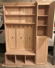 an unfinished wooden bookcase with shelves and cupboards