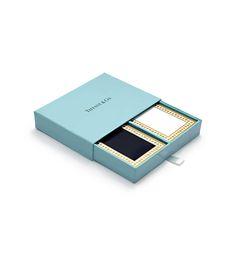 a blue box with two cards inside and one in it's bottom open, on a white background