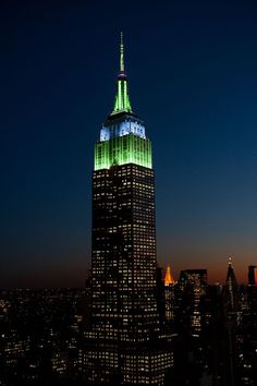 the empire building lit up in blue and white