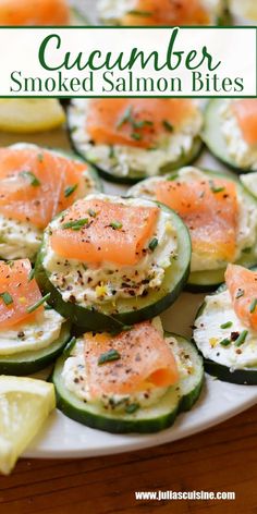 cucumber smoked salmon bites on a plate with lemon wedges