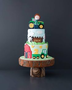 a three tiered cake decorated with farm animals and farmer's names on it